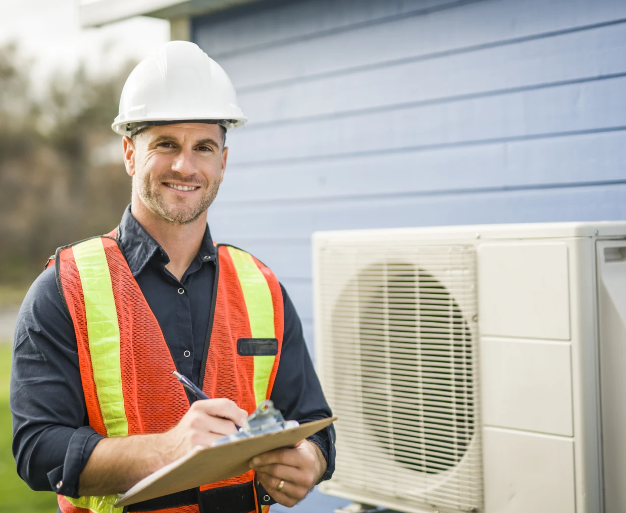 Smiling worker with clipboard near air conditioner.