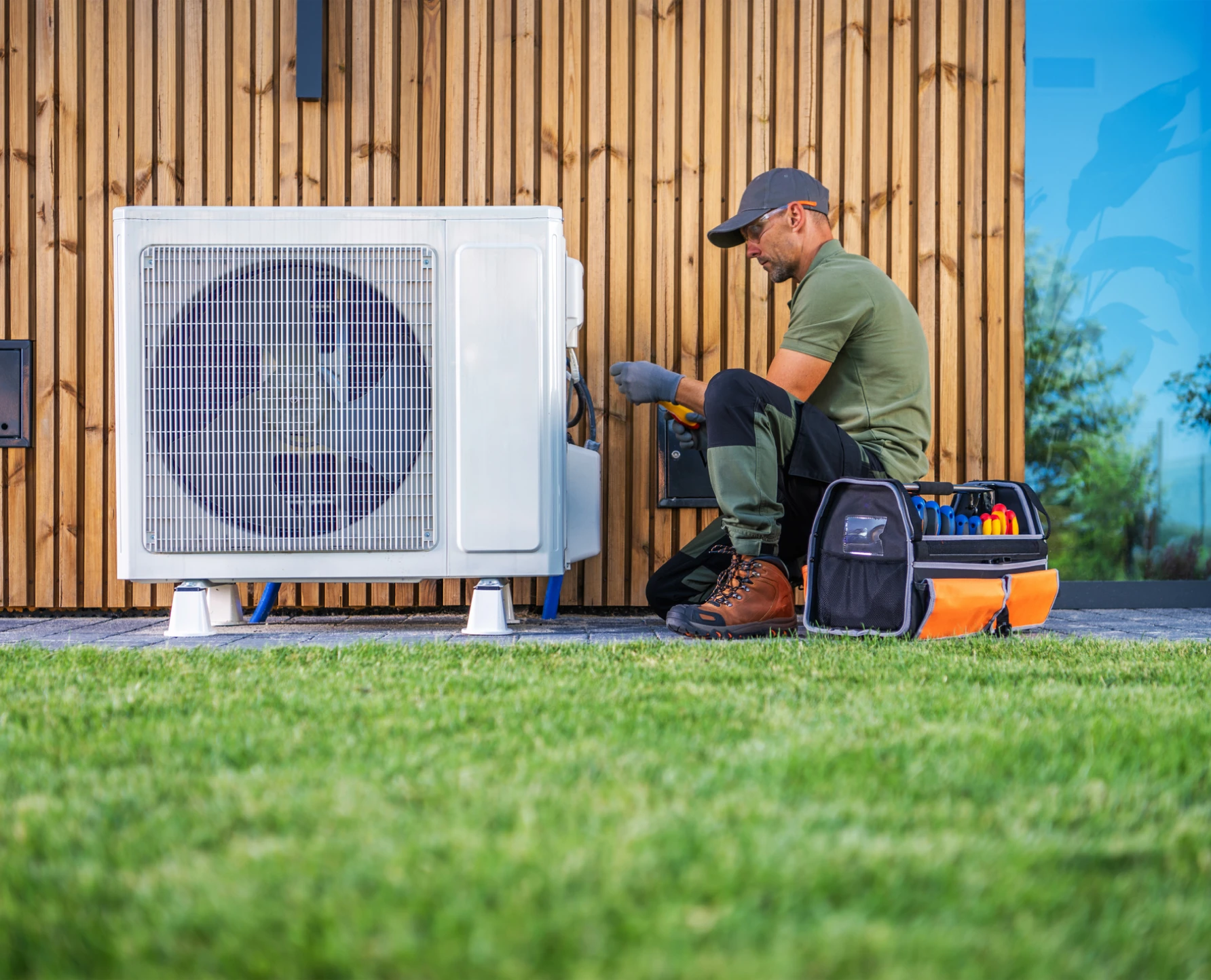 Technician repairing outdoor air conditioning unit.